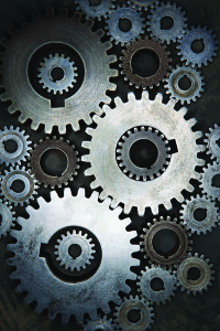 Various silver metal gears intersecting.